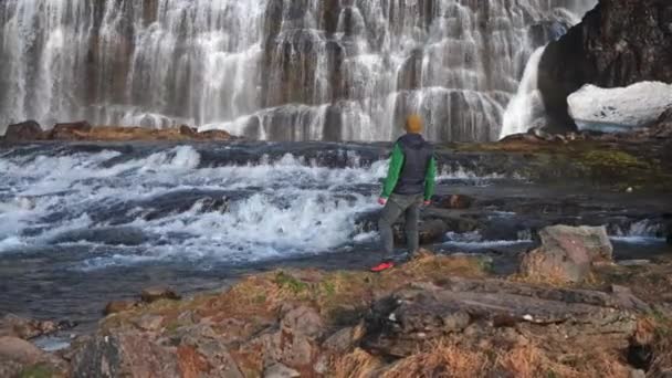 Wide Zoom Slow Motion Shot Man Standing Rocks Looking Dynjandi — Stock video