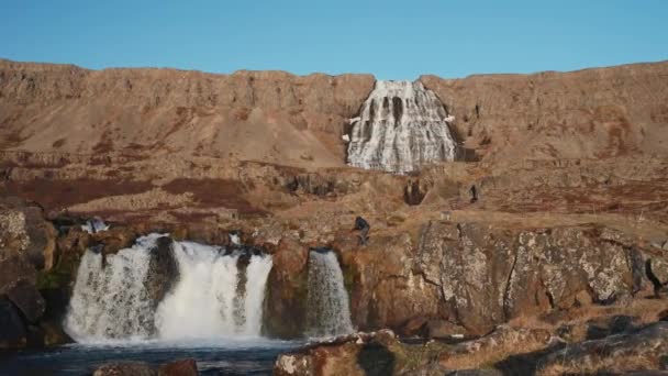 Wide Slow Motion Zoom Photographer Stepping Rocks Photograph Dynjandi Waterfall — Stockvideo