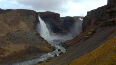 Aerial of Majestic Haifoss Waterfall, River and the Valley. Spectacular Scenery of Iceland.  Wide Panoramic Shot. Camera Moves Forwards
