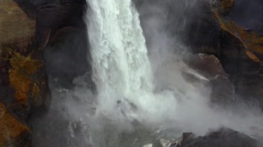 Aerial Over Majestic Haifoss Waterfall. Spectacular Scenery of Iceland. Water Rapidly Falls Down with Power. Tilt Down Slow Motion Shot