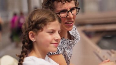 Close-up Portrait of a Mother with Her Young Teenage Daughter Enjoying the View from the Brooklyn Bridge. Popular Tourist Destination of New York. Slow Motion Racking Focus Shot