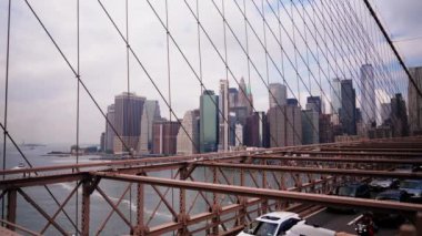 Cars Driving Along the Brooklyn Bridge. View From Pedestrian Side on Traffic, Cables and Metal Constructions of the Bridge. Slow Motion Static Shot