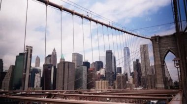 View on Manhattan Skyscrapers  Through Cables of Brooklyn Bridge. Cityscape of New York. Famous Landmark. Panning Shot