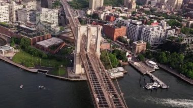 Aerial Over Brooklyn Bridge with Traffic and East River New York. Panoramic Wide Tilt Down Shot. Camera Flies High Over the Bridge
