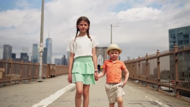 Teenage Girl Her Little Brother Holding Hands Walking Brooklyn Bridge — Stock video