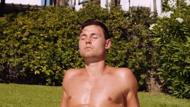 Slow Motion Medium Handheld Shot Young Man Sunbathing Eyes Closed — Vídeo de Stock