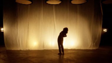 Profesyonel Dansçı Sahne Perdesine Karşı Stüdyoda Sahne Arkası Yumuşak Işıklı. Afro saç stili Afro-Amerikalı Kadın Flashing Spotlights 'a bakıyor. Yavaş Hareket Görüntüsü