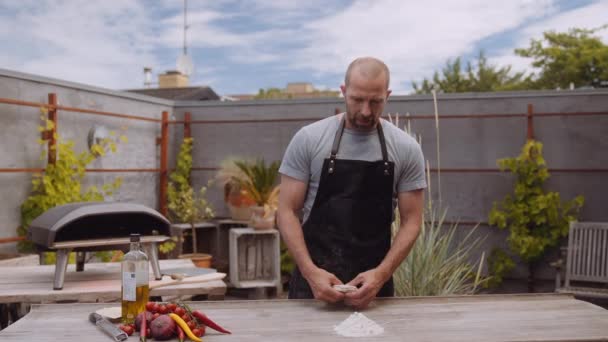 Slow Motion Medium Handheld Shot Man Apron Kneading Dough Table — Stock Video