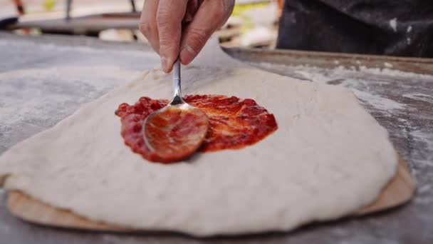 Handheld Slow Motion Close Shot Man Spreading Tomato Pizza Sauce — Stock Video