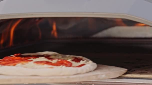 用比萨饼垫把比萨饼放进室外小比萨饼中慢动作射击 — 图库视频影像