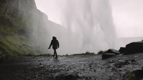 Hombre Fotógrafo Caminando Detrás Cascada Seljalandsfoss Islandia Agua Cae Con — Vídeo de stock