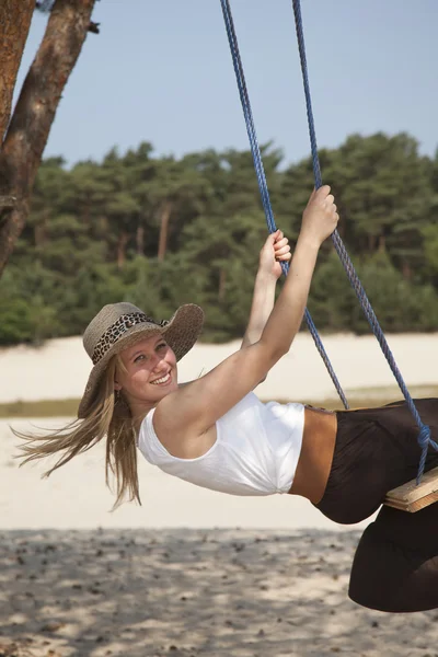 Swinging lady in nature — Stock Photo, Image