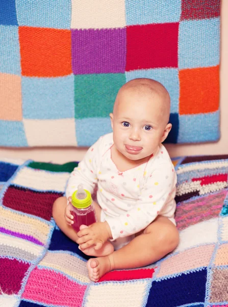 Baby girl holding a bottle — Stock Photo, Image