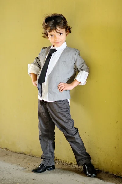 Portrait of little stylish boy outdoors in a suit — Stock Photo, Image