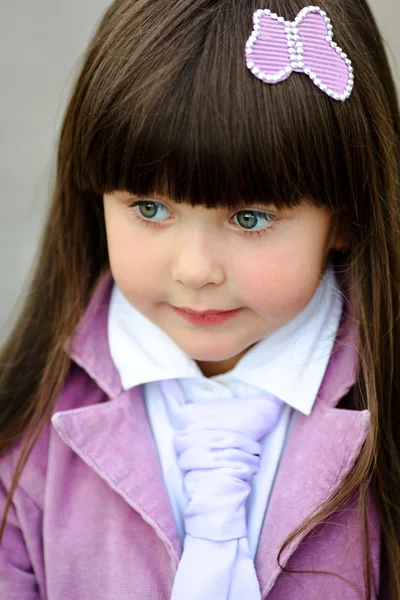 Porträtt av lilla flicka utomhus i en rosa jacka — Stockfoto