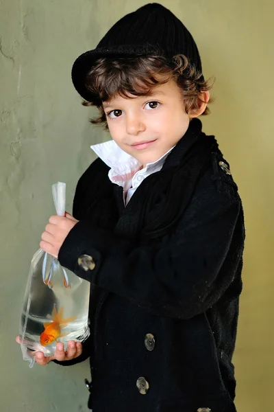 Portrait of little stylish boy outdoors with a goldfish — Stock Photo, Image