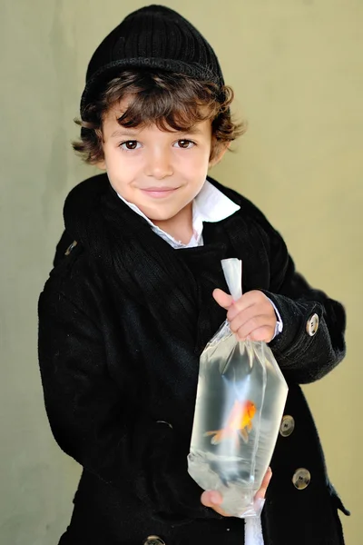 Retrato de un niño con estilo al aire libre con un pez de colores —  Fotos de Stock