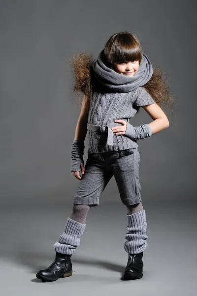 Portrait of a little girl on a gray background — Stock Photo, Image