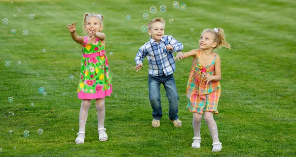 Portrait of three friends with soap bubbles — Stock Photo, Image