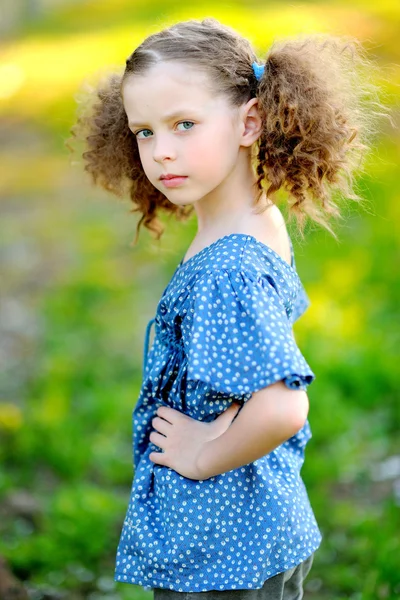 Portrait of little girl outdoors in summer Stock Photo by