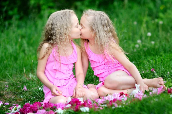 Portrait of two twins with peonies — Stock Photo, Image