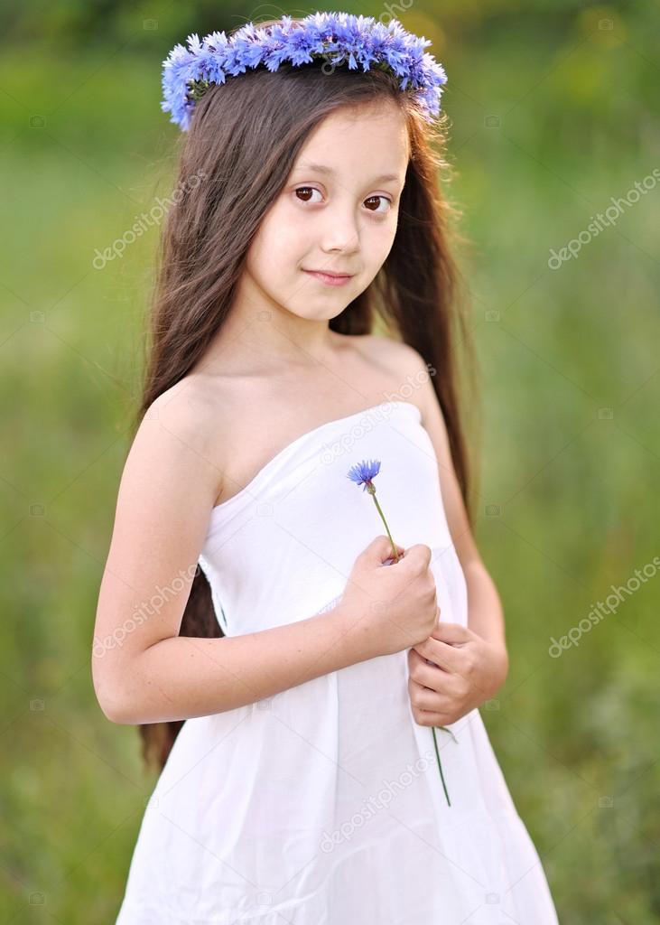 portrait of little girl outdoors in summer