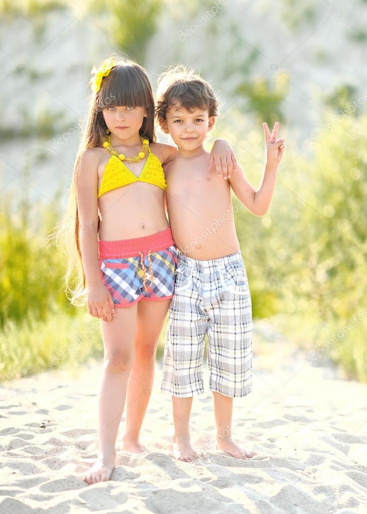 Portrait of children on the beach in summer