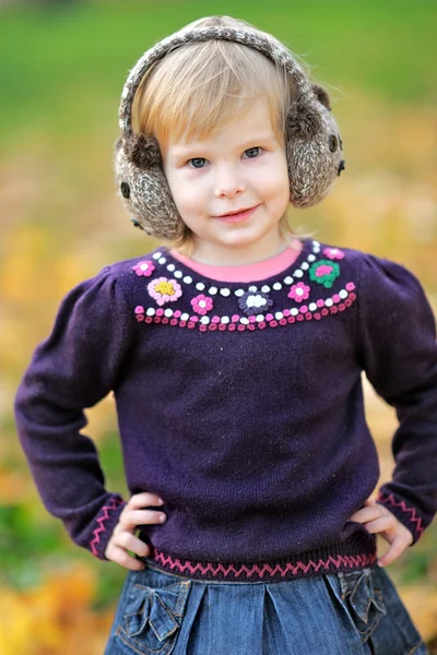 Portrait of a little girl in a park in autumn — Stock Photo, Image