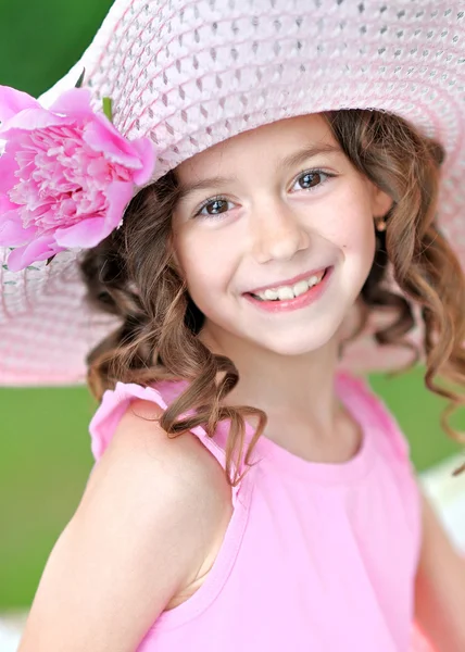 Portrait of a beautiful little girl with peony — Stock Photo, Image