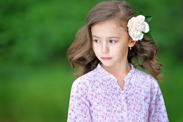 Portrait of a beautiful little girl with peony — Stock Photo, Image