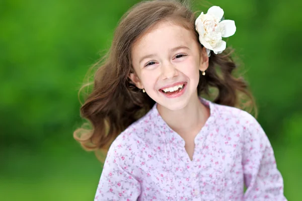 Portrait of a beautiful little girl with peony — Stock Photo, Image
