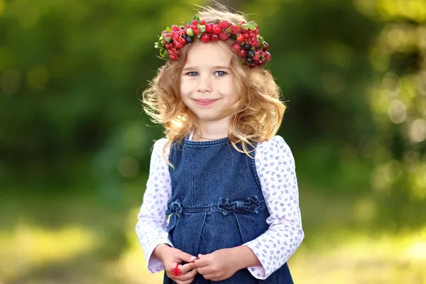 Portrait of a beautiful little girl with berries — Stock Photo, Image