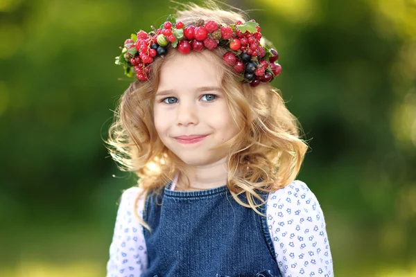 Portrait of a beautiful little girl with berries — Stock Photo, Image