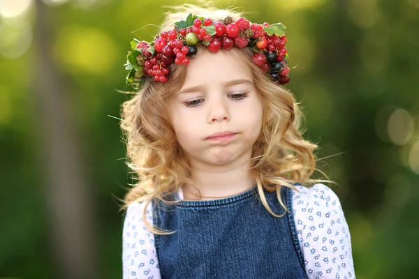 Portrait of a beautiful little girl with berries — Stock Photo, Image