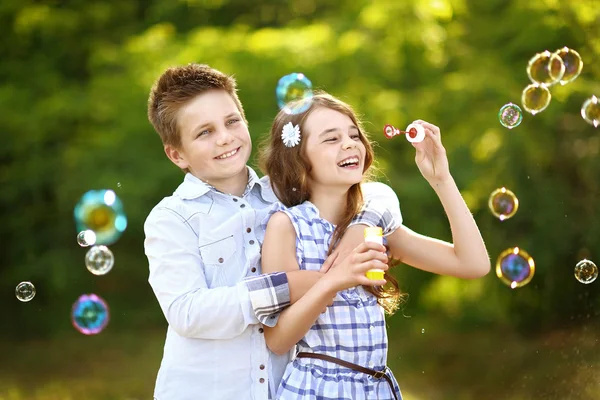 Portrait of a boy girl in a summer with bubble — 图库照片