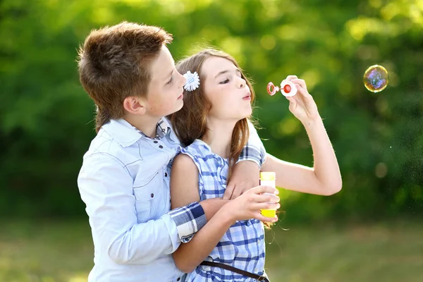 Portrait of a boy girl in a summer with bubble — 图库照片