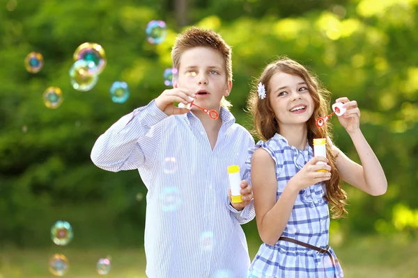 Portrait of a boy girl in a summer with bubble — 图库照片