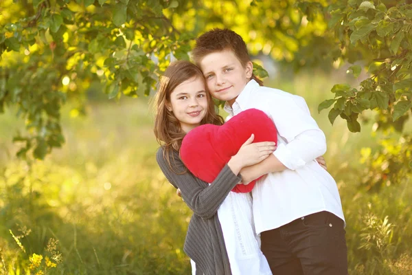 Portrait of a boy girl in a summer with heart — Stock Photo, Image