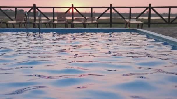 Вид зверху на басейн з чистою водою у відпустці на фоні заходу сонця — стокове відео