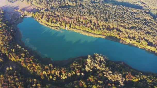 Scénická krajina jezera mezi svěžími barevnými stromy při západu slunce — Stock video