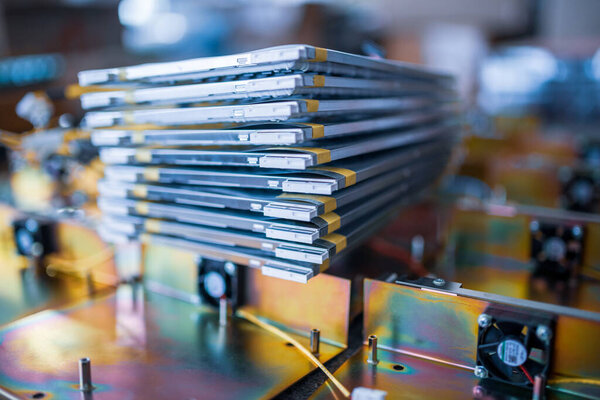 Stack of matrix for contemporary TFT liquid crystal displays and metal details in assembling workshop of production plant extreme closeup