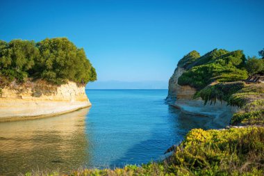 Blue sea water straight between islands with forests