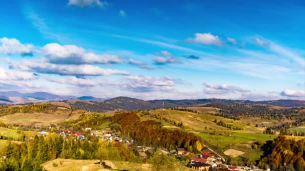 Malá vesnice na vysočině pod modrou oblohou s těžkými mraky — Stock video