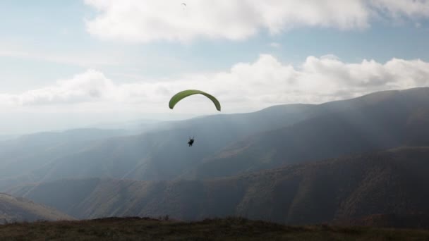 Paralotniarstwo w górach przeciwko olbrzymim górom leśnym — Wideo stockowe