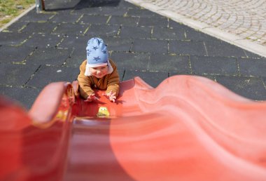 Sonbahar havasında bir çocuk arabasını bir tepede sürüyor.