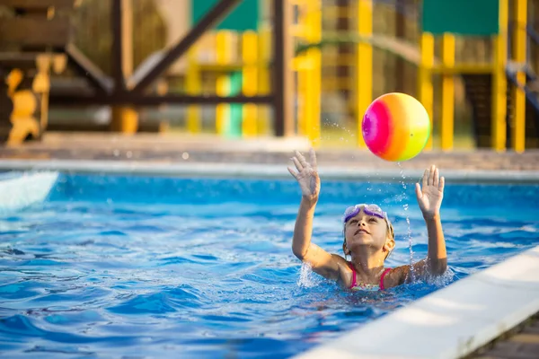 Young Girl Bright Leopard Swimsuit Swims Bright Colored Inflatable Ball — стоковое фото