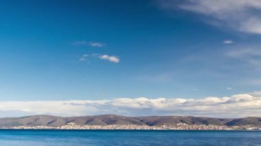 View of magical brilliant bewitching reflection in calm blue quiet Black Sea, against background of sea horizon with cloudy multi-colored sky and bright evening sunset. 4K UHD timelapse video