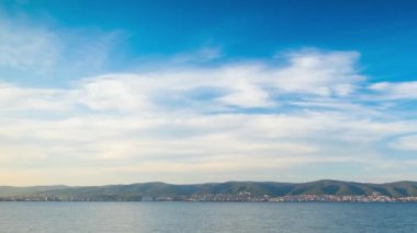 View of magical brilliant bewitching reflection in calm blue quiet Black Sea, against background of sea horizon with cloudy multi-colored sky and bright evening sunset. 4K UHD timelapse video