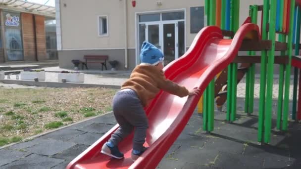 Cheerful Funny Little Boy Blue Hat Warm Clothes Plays Playground — Vídeos de Stock
