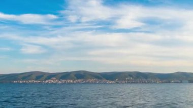 View of magical brilliant bewitching reflection in calm blue quiet Black Sea, against background of sea horizon with cloudy multi-colored sky and bright evening sunset. 4K UHD timelapse video